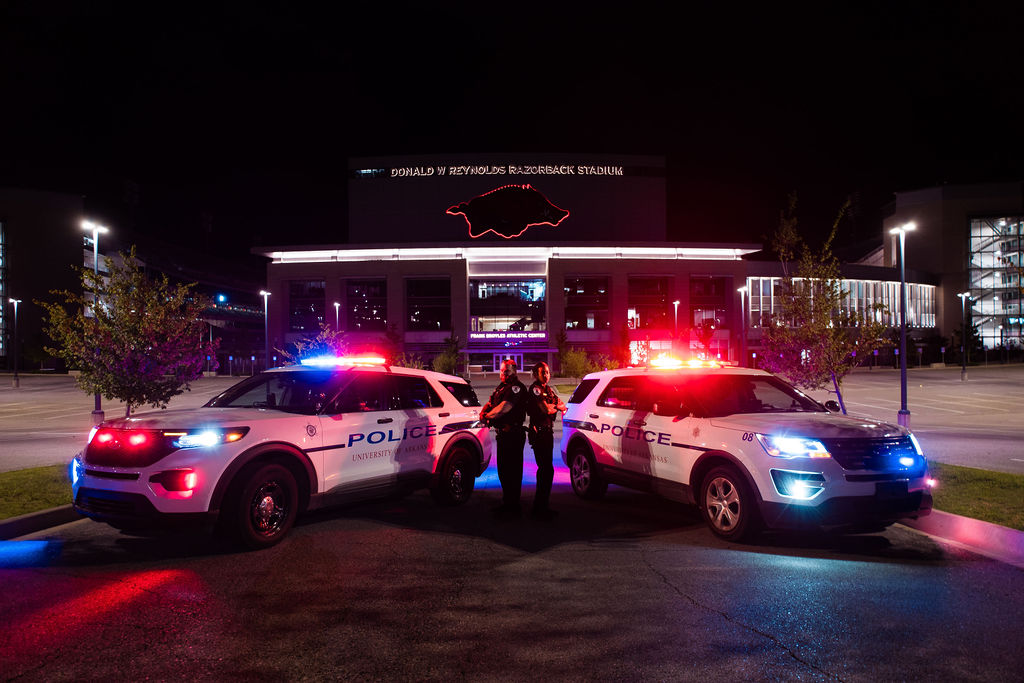 police officers in front of razorback stadium